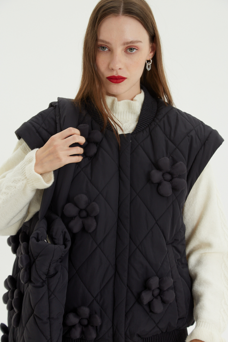 Campera matelaseada con apliques 3D de flores puffer, cuello y puños de ribb, cierre doble camino y mangas desmontables. 
