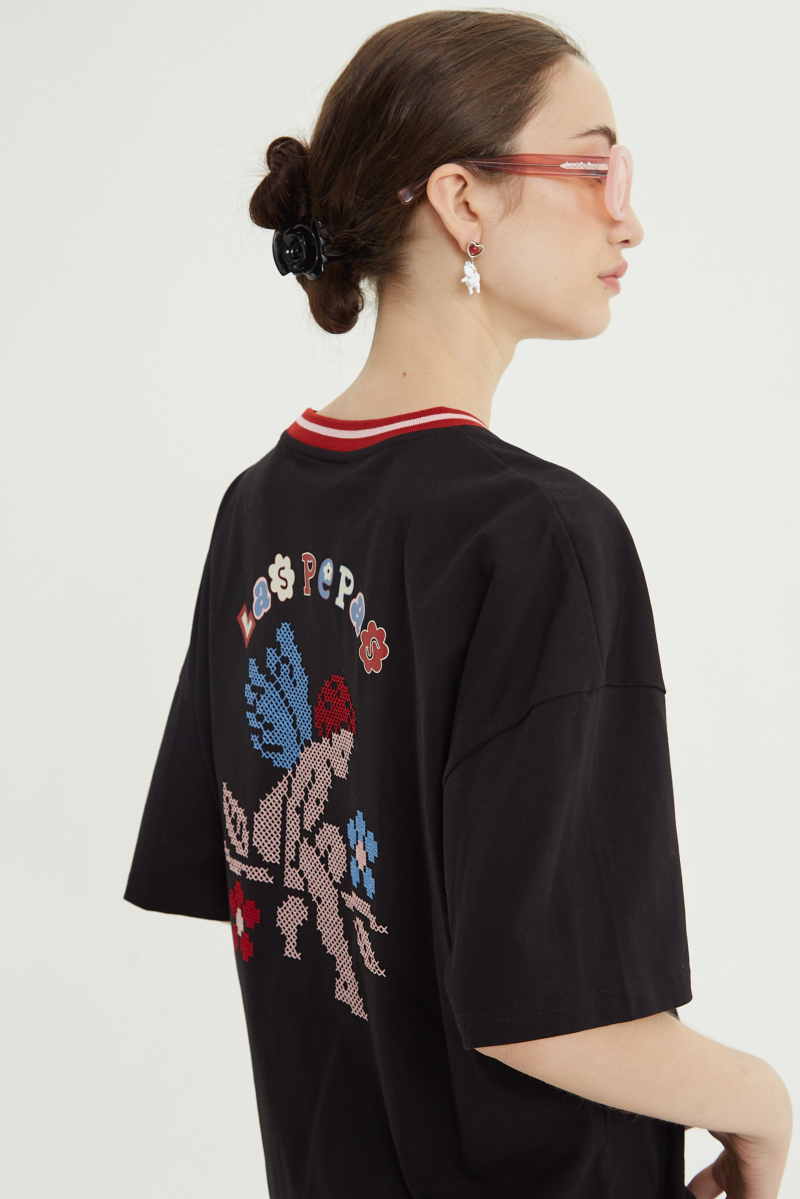 Remera oversize de algodón con bordado en punto cruz al frente y estampa en la espalda. 
