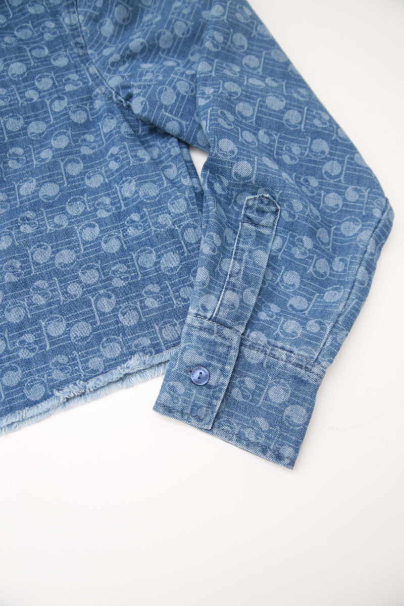 Camisa estampada amplia y crop de jean con ruedo desflecado.
