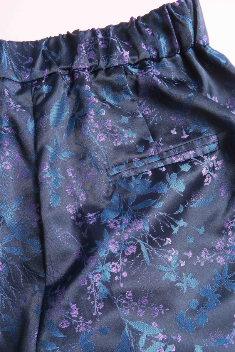 Pantalón azul sastrero tiro alto y recto confeccionado en jacquard satinado con motivo floral. 
