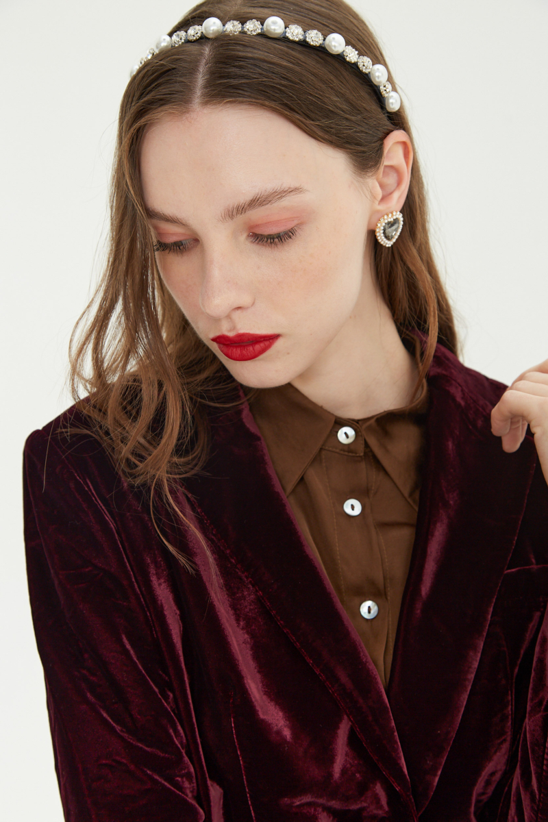 Blazer bordo sastrero con hombreras de corte recto con pinzas de entalle y largo hasta la cadera.