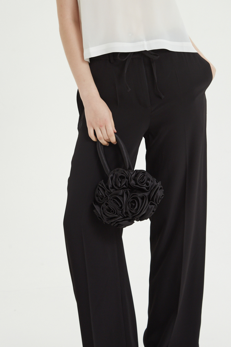 Pantalón negro sastrero tiro alto recto y largo a los tobillos con cintura con elástico y lazo a tono para atar. 